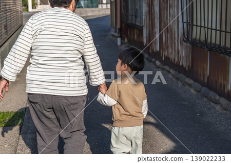 Grandmother and grandchild walking hand in hand Grandmother and grandchild walking hand in hand 139022233