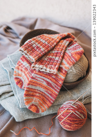 Hand knitted socks with needles and yarn ball. Concept for handmade and hygge slow life. 139022343