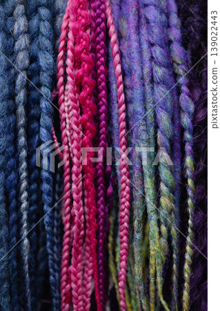 Colorful braid extensions texture background with multicolor strands Colorful braid extensions texture background with multicolor strands 139022443