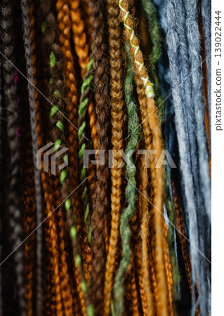Natural tone braid extensions texture background with mixed strands Natural tone braid extensions texture background with mixed strands 139022444