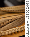 Blonde braid extensions on wooden table with metal rings 139022449