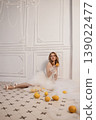 Woman On Tiles Playing With Fruit. Candid Scene Of Bride Enjoying Citrus Amid Retro Decor 139022477