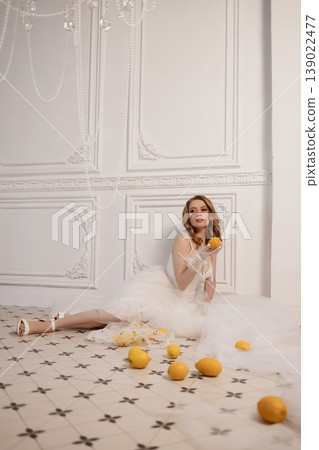 Woman On Tiles Playing With Fruit. Candid Scene Of Bride Enjoying Citrus Amid Retro Decor Woman On Tiles Playing With Fruit. Candid Scene Of Bride Enjoying Citrus Amid Retro Decor 139022477