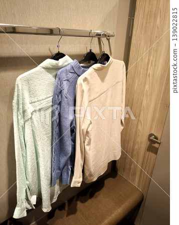 Women's clothing on hangers in a store's fitting room 139022815
