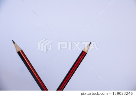 Two wooden pencils isolated on white background with large copy space. Minimal education and study concept for school, learning, writing and academic workspace. Two wooden pencils isolated on white background with large copy space. Minimal education and study concept for school, learning, writing and academic workspace. 139023246