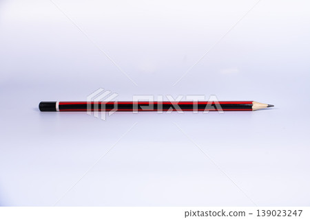 Single wooden pencil isolated on white background with large copy space. Minimal stationery concept for education, writing, drawing, school supplies and academic workspace. Single wooden pencil isolated on white background with large copy space. Minimal stationery concept for education, writing, drawing, school supplies and academic workspace. 139023247