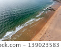 Aerial view of ocean waves reaching sandy beach 139023583