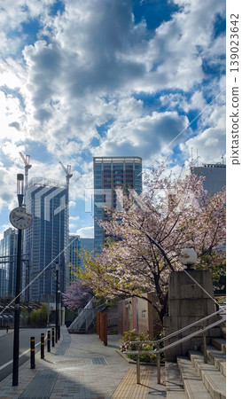 A pedestrian bridge and high-rise buildings along the Meguro River, where cherry blossoms are in bloom. A pedestrian bridge and high-rise buildings along the Meguro River, where cherry blossoms are in bloom. 139023642