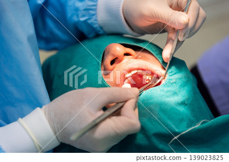 Close up dental surgery with dentist using tools on patient mouth in clinic sterile environment oral care treatment and medical precision procedure concept 139023825