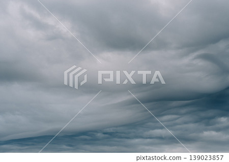 A thick, overlapping, undulating gray, overcast sky. A thick, overlapping, undulating gray, overcast sky. 139023857