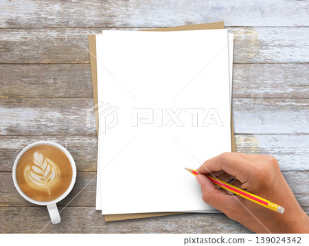 Hand holding pencil,blank white and brown paper and coffee on wood table background. Hand holding pencil,blank white and brown paper and coffee on wood table background. 139024342
