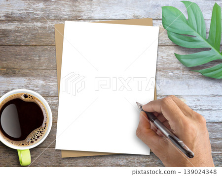 Blank white and brown paper and fresh green leaves on wood table background. Blank white and brown paper and fresh green leaves on wood table background. 139024348