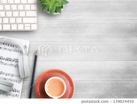 White head phone,keyboard and sheet music on white wood table background. White head phone,keyboard and sheet music on white wood table background. 139024450