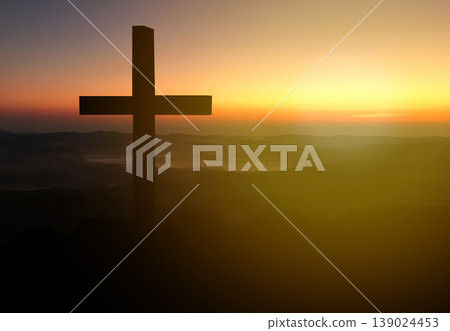 Silhouette christian cross on grass in sunrise background. Silhouette christian cross on grass in sunrise background. 139024453