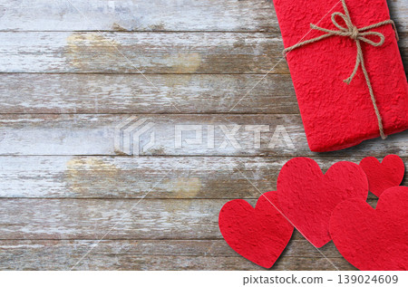 Red paper heart and red gift box on wooden table background. Red paper heart and red gift box on wooden table background. 139024609