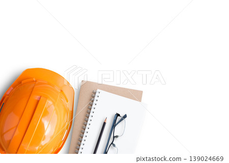 Top view with orange safety engineer helmet and blank notebook Top view with orange safety engineer helmet and blank notebook 139024669