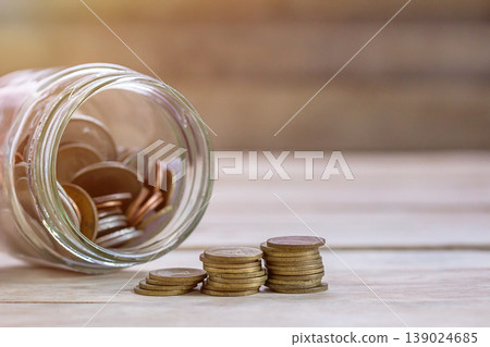 Money in the jar on wooden table with filter effect retro vintage style 139024685