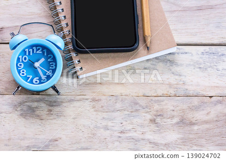 Top view of office desk with blank empty notepad or notebooks on wood table Top view of office desk with blank empty notepad or notebooks on wood table 139024702