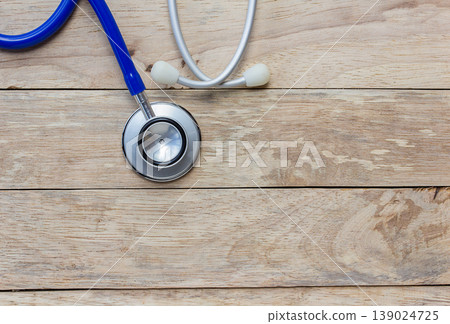Top view of blue stethoscope equipment on wood table background. Top view of blue stethoscope equipment on wood table background. 139024725
