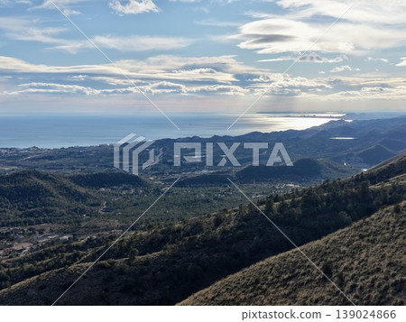 Gentle Slopes Meet Shimmering Water, Serene Scenery With Rolling Hills And Distant Shoreline Beyond Gentle Slopes Meet Shimmering Water, Serene Scenery With Rolling Hills And Distant Shoreline Beyond 139024866