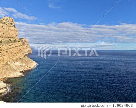 Peaceful Seaside Cliffs With Waves, Scenic Oceanfront With Limestone Steps Beneath Cloudy Sky Peaceful Seaside Cliffs With Waves, Scenic Oceanfront With Limestone Steps Beneath Cloudy Sky 139024908