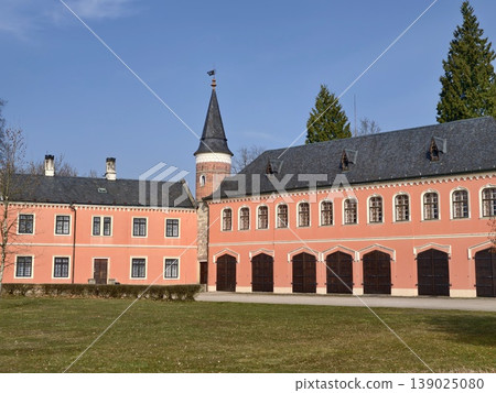 Colorful Structure With Tower And Arches. Bright Pink Front With Corner Tower And Large Windows Colorful Structure With Tower And Arches. Bright Pink Front With Corner Tower And Large Windows 139025080