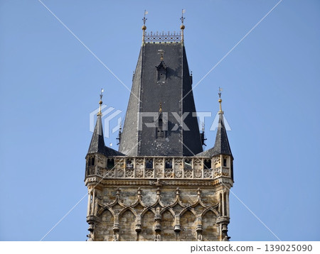 Vivid Sky Complements Buildings. Bright Blue Sky Emphasizes Detailed Gothic Structures Beautifully Vivid Sky Complements Buildings. Bright Blue Sky Emphasizes Detailed Gothic Structures Beautifully 139025090