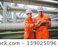 Oil and Gas Engineers Reviewing Operational Plans at Pipeline Section of Refinery Plant 139025096