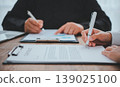 businessman is negotiating, advising, and explaining the matter of the contract to be agreed to sign the contract. 139025100