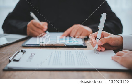 businessman is negotiating, advising, and explaining the matter of the contract to be agreed to sign the contract. 139025100