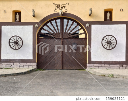 Vintage Rural Entrance. Traditional Country Gateway Showcasing Aged Wood And Classic Design Elements Vintage Rural Entrance. Traditional Country Gateway Showcasing Aged Wood And Classic Design Elements 139025121