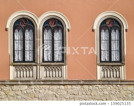 Arch Windows With Stucco Texture. Urban Scene Featuring Arched Windows And Textured Facade Charm Arch Windows With Stucco Texture. Urban Scene Featuring Arched Windows And Textured Facade Charm 139025135