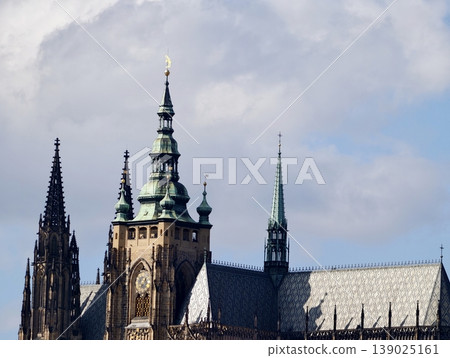 Ancient Church Spires Rise High. Ornate Cathedral Pinnacles Contrast With Weathered Copper Roofs Overhead 139025161