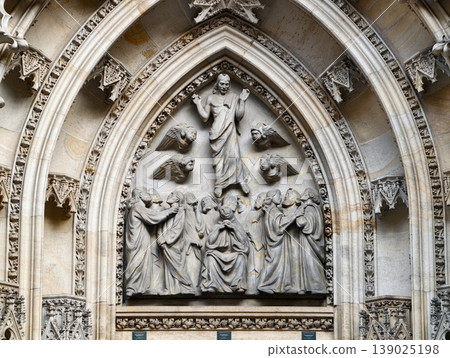 Ornate Gothic Stone Relief Showcasing Christ Enthroned Amid Apostles And Carved Saints With Aged Patina 139025198