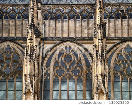 Architectural Feature Showcasing Towering Gothic Windows With Ornate Tracery And Weathered Sandstone Details 139025200