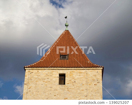 Ancient Tower Scene. Old Stone Edifice Featuring Weather Vane And Textured Masonry Surface 139025207