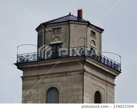 Ancient Watchtower Exhibiting Worn Stone Surfaces And Detailed Wrought Iron Balcony Under Cloudy Sky Ancient Watchtower Exhibiting Worn Stone Surfaces And Detailed Wrought Iron Balcony Under Cloudy Sky 139025504