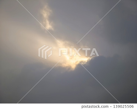Tranquil Scene Showcasing Radiant Sunlight Breaking Through Heavy Overcast And Soft Atmospheric Haze 139025506