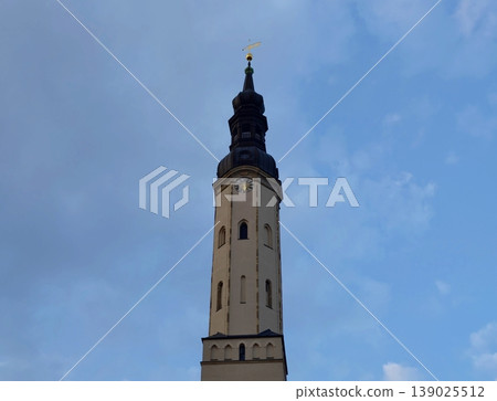 Elevated Narrow Tower Reaching For Sky. Elegant Slim Spire Against Wide Open Blue Sky Landscape 139025512