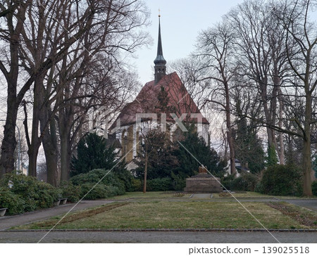 Serene Historic Site. Calm And Reflective Medieval Chapel Nestled Among Barren Trees In Winter Park Scene Serene Historic Site. Calm And Reflective Medieval Chapel Nestled Among Barren Trees In Winter Park Scene 139025518