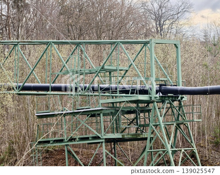 Old Pipeline System Standing Amidst Leafless Woods Under Gloomy Sky Evoking Resilience And Decay 139025547