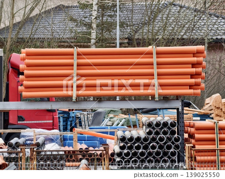 Brightly Colored Conduit And Drainage Tubes Arranged Neatly Among Fittings In Construction Yard Brightly Colored Conduit And Drainage Tubes Arranged Neatly Among Fittings In Construction Yard 139025550