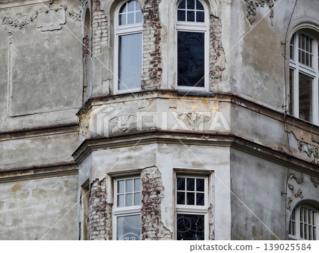 Facade Of Ornate Building Showcasing Fractured Stucco And Aged Decorative Features For Assessment Facade Of Ornate Building Showcasing Fractured Stucco And Aged Decorative Features For Assessment 139025584