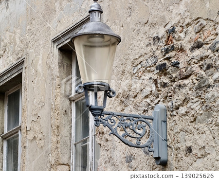 Traditional Wall Mounted Lantern With Aged Patina And Intricate Metalwork For Historic Building Ambiance Traditional Wall Mounted Lantern With Aged Patina And Intricate Metalwork For Historic Building Ambiance 139025626