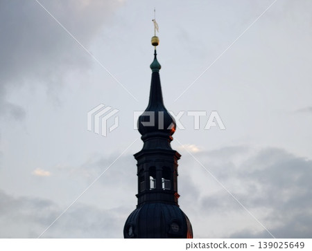 Historic Towers And Vibrant Sky. Traditional Steeples Stand Out Against Atmospheric Overcast Skies Historic Towers And Vibrant Sky. Traditional Steeples Stand Out Against Atmospheric Overcast Skies 139025649
