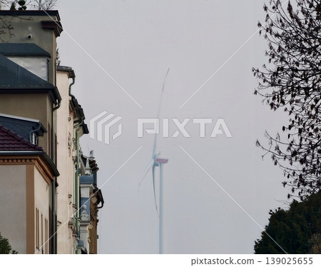 Cityscape With Turbines And Heritage. Overcast City Scene With Wind Turbines And Historic Building Details Cityscape With Turbines And Heritage. Overcast City Scene With Wind Turbines And Historic Building Details 139025655