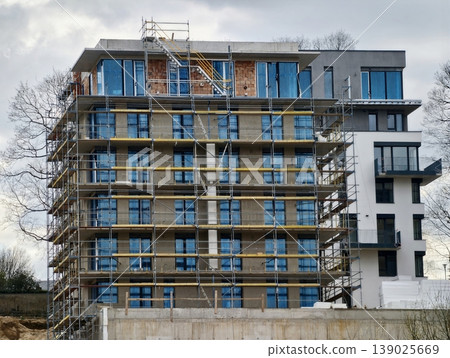 Construction Workers Prepare Exterior. Scaffolding And Equipment Ready For Building Renovation Effort 139025669