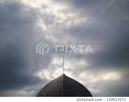 Clouds Over Antenna With Mood. Overcast Sky Features Textured Tiles And Urban Silhouette Outline Clouds Over Antenna With Mood. Overcast Sky Features Textured Tiles And Urban Silhouette Outline 139025672