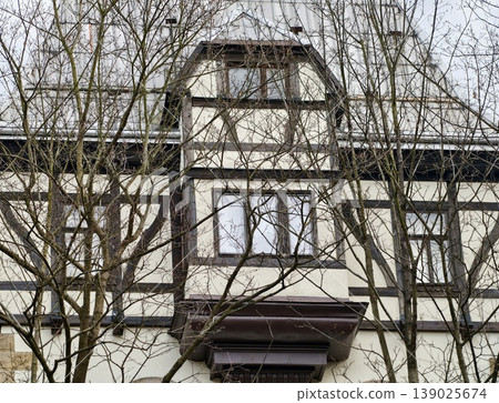 Winter Scene With Rustic Charm. Classic House Facade With Traditional Features And Aged Textures 139025674