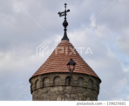 Medieval Tower With Weather Vane. Restorationready Medieval Masonry Featuring Weather Vane And Lamp Medieval Tower With Weather Vane. Restorationready Medieval Masonry Featuring Weather Vane And Lamp 139025681